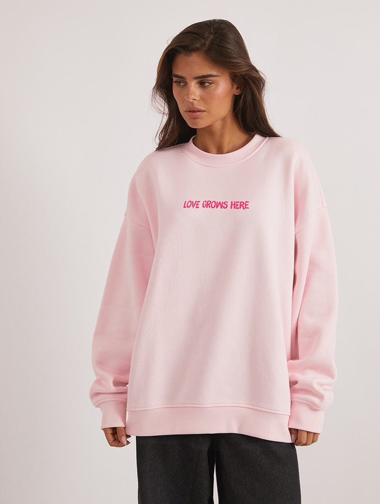 Love Grows Here Sweatshirt In Pink Hoodies & Sweatshirts Skinnydip London
