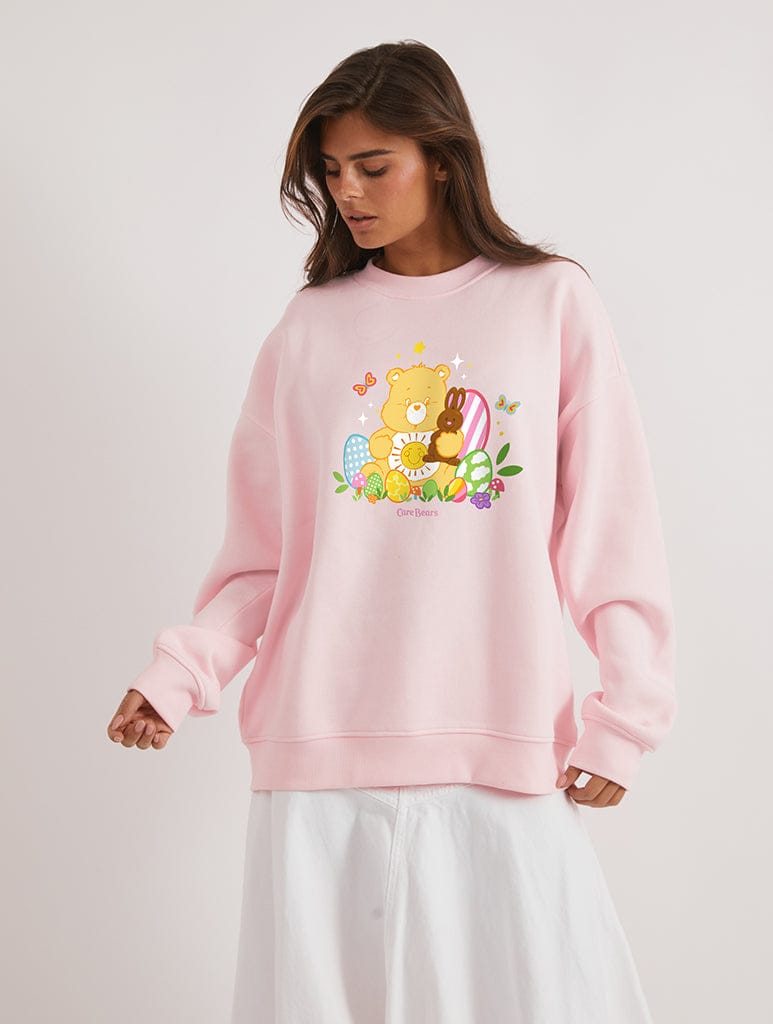 Care Bears x Skinnydip Funshine Bear Easter Egg Sweatshirt In Pink Hoodies & Sweatshirts Skinnydip London